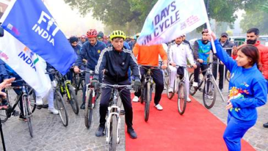 गच्चीबावली स्टेडियम में साइकिल चलाते पत्रकार और प्रतिभागी